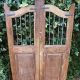 Wooden garden gate with vertical iron bars