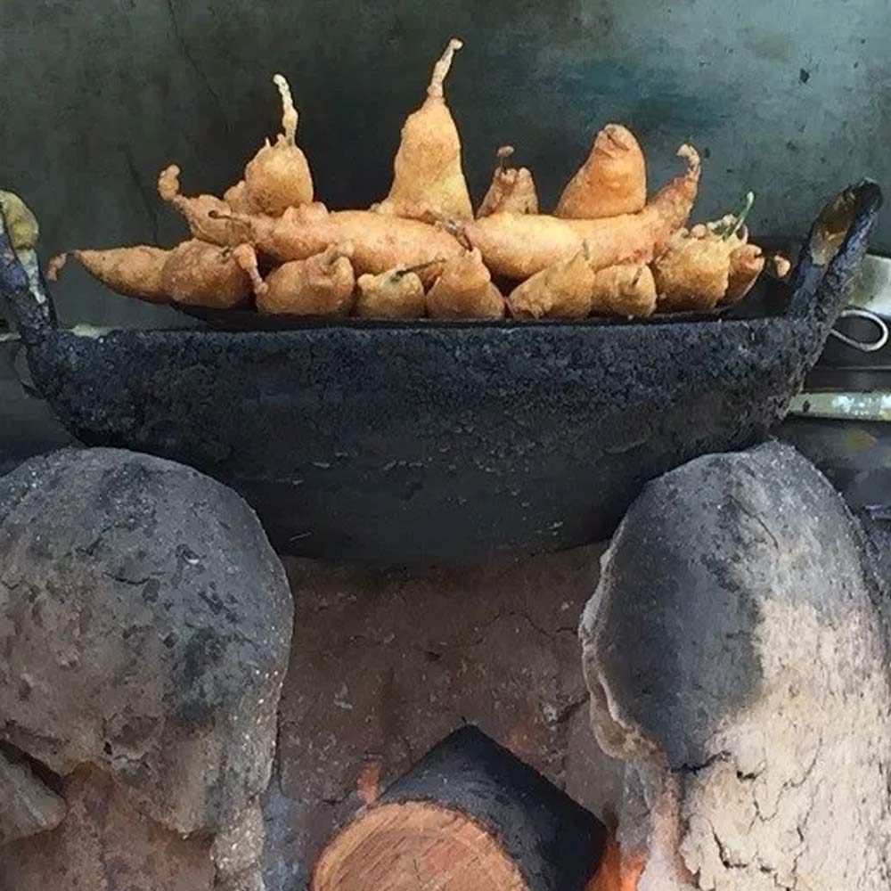 iron cooking bowl over a fire in India