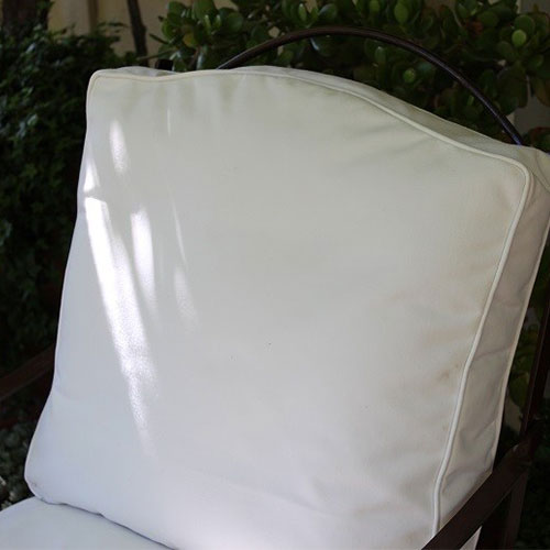 A chair with a white cushion on it