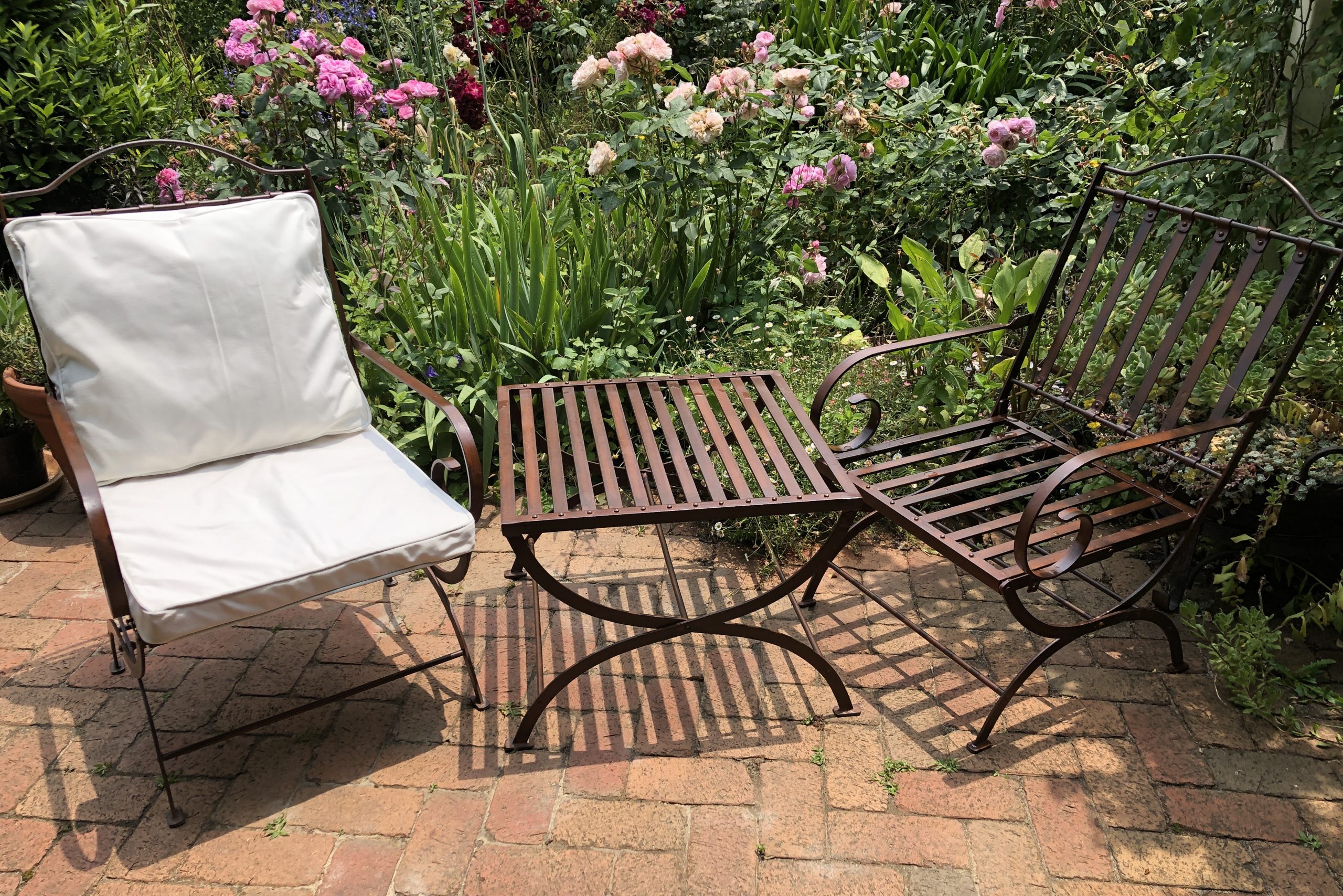 wrought iron chairs and table in a garden