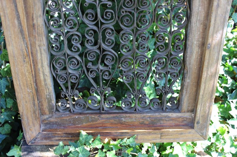 wrought iron scrollwork in a timber frame
