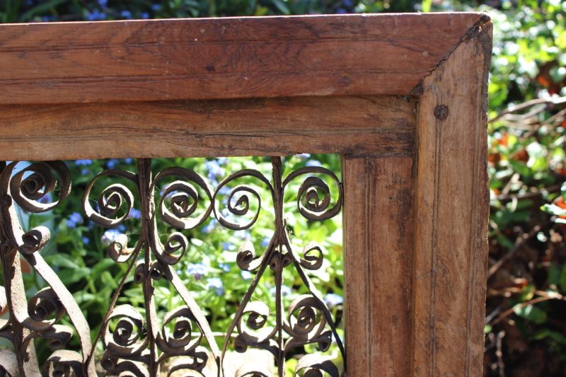 Metal scrollwork in a timber frame