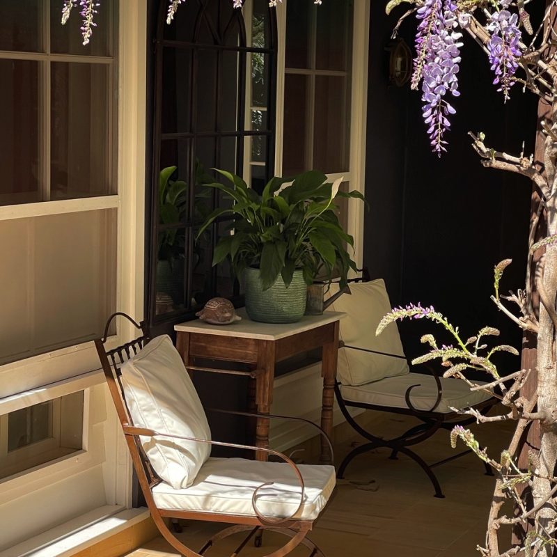 armchair under wisteria on a patio