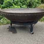 Fire pit with rivets in a garden