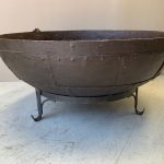 iron pot with rivets on a stand