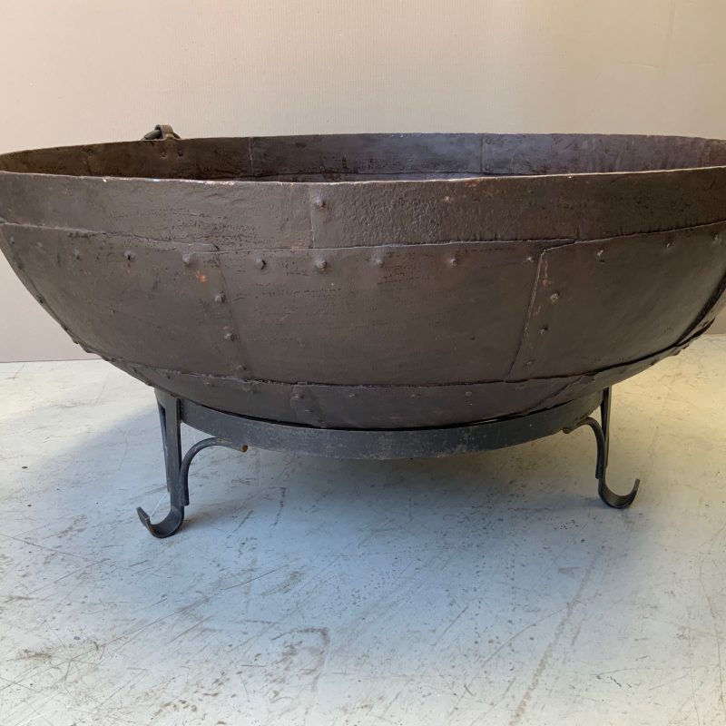 iron pot with rivets on a stand